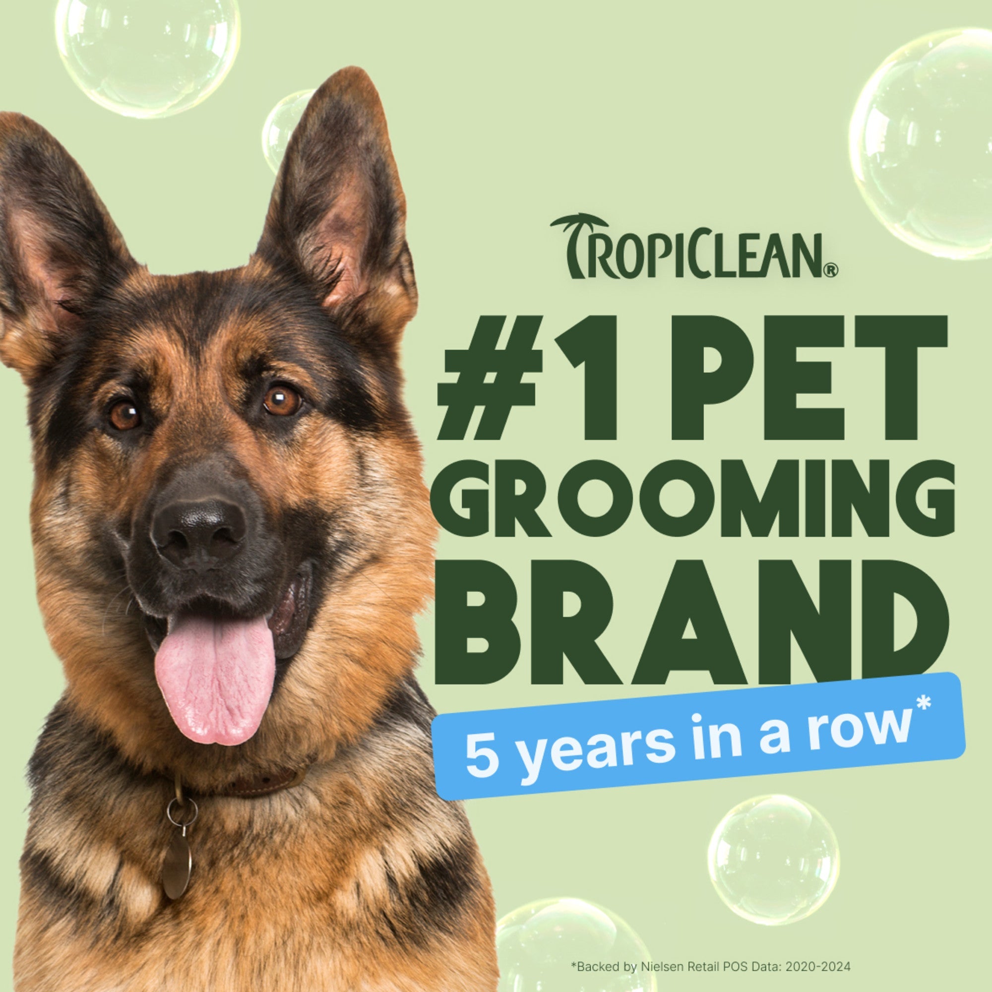 German Shepherd with Tropiclean branding claiming #1 pet grooming brand for 5 years on a light green background.