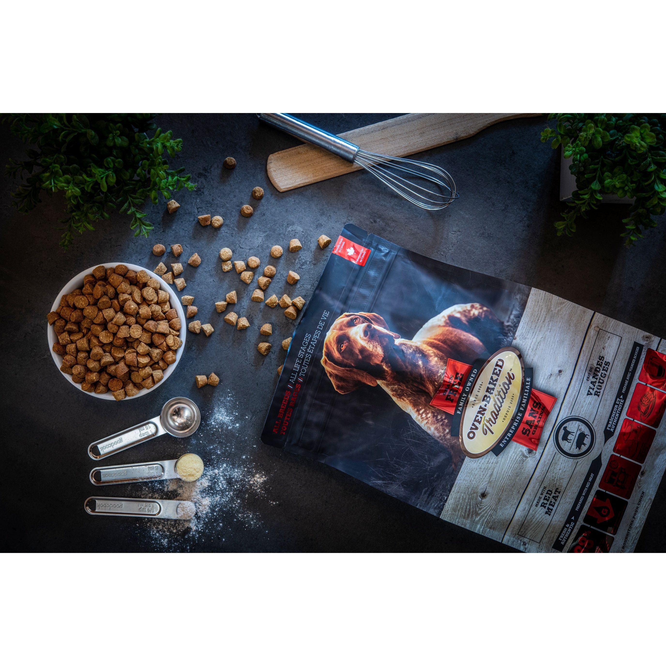 Dog food packaging with ingredients on a dark surface