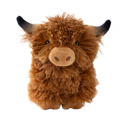 Plush toy of a brown highland cow on a white background